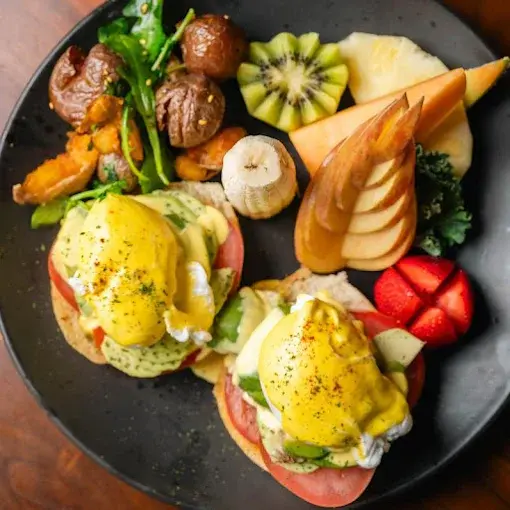Tomato and Avocado Benedict at VIBE Breakfast & Grill in Calgary